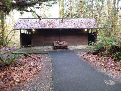 One of four accessible restrooms off Streamwatch Trail – carving of salmon on bench – paved surface
